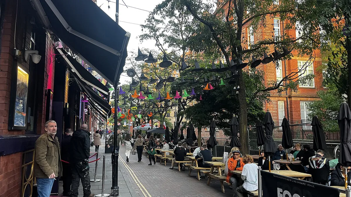 Rainbow flags and canalside bars along Canal Street in Manchester's Gay Village — 1
