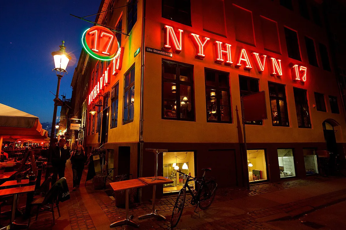 Copenhagen nightlife street scene with bars in Nyhavn at night — 2