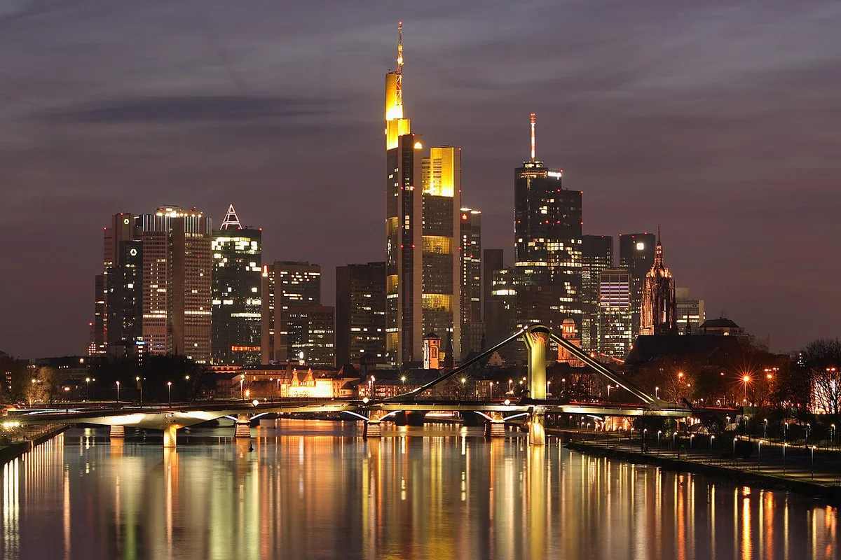 Frankfurt's Mainhattan skyline lit up at night above the Main river — 1