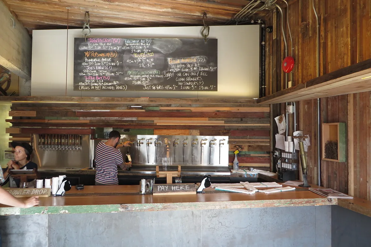 Interior of a Riga craft beer taproom with tap handles