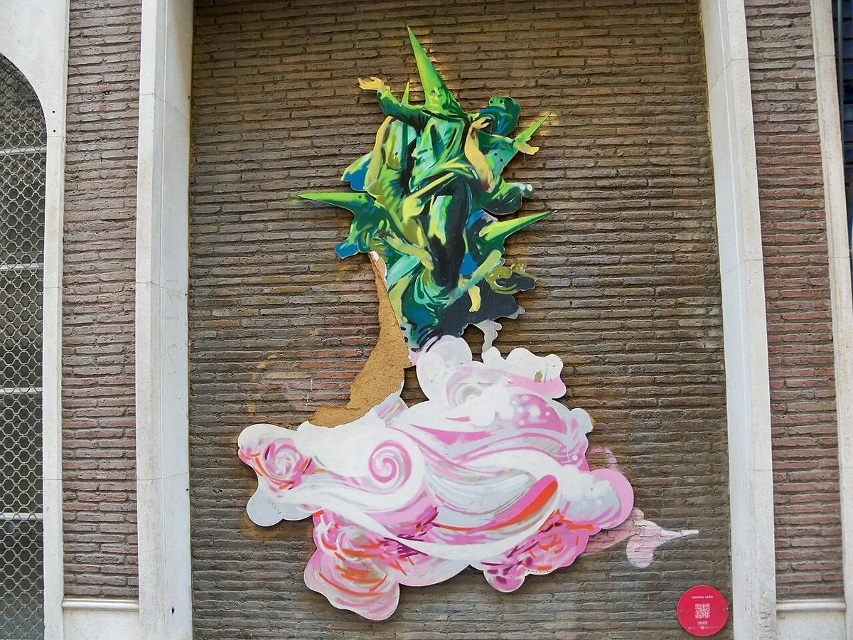 Street art murals lining a bar-filled street in the Soho district of Malaga at night — 2